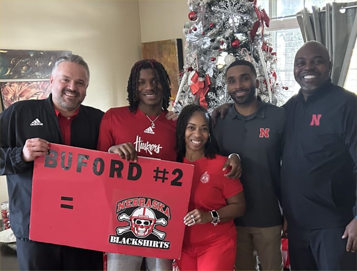 Mario Buford with his parents and coaches Matt Rhule and Evan Cooper.